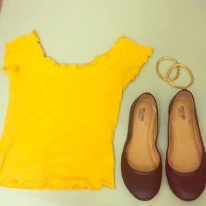 Yellow cropped shirt. Maroon Flats. Gold bracelets